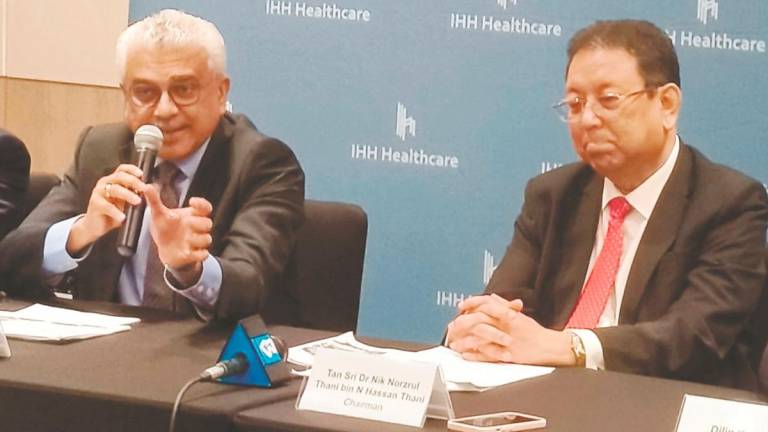 Dr Prem (left) with IHH Healthcare chairman Tan Sri Dr Nik Norzrul Thani N Hassan Thani at a press conference after the company’s annual general meeting yesterday.