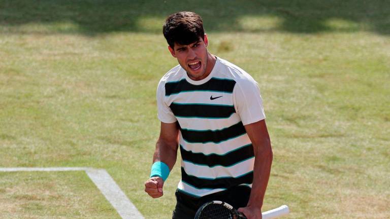 Spain's Carlos Alcaraz celebrates winning against Australia's Adam Walton during their men's singles round of 32 tennis match at the HSBC ATP tennis Championships at Queen's Club in west London on June 17, 2025. - AFPPIX