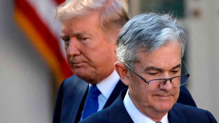 FILE PHOTO: U.S. President Donald Trump looks on as Jerome Powell, his nominee at the time to lead the U.S. Federal Reserve, moves to the podium at the White House in Washington, U.S., November 2, 2017. REUTERS
