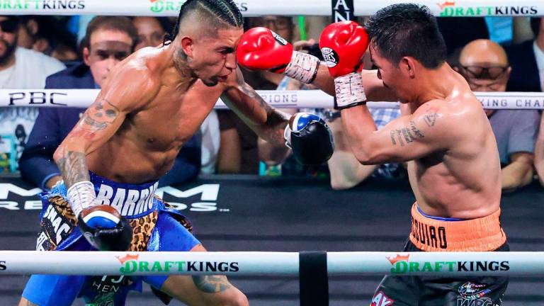 Manny Pacquiao (R) throws a right at Mario Barrios in the 12th round of their WBC welterweight title fight at MGM Grand Garden Arena on July 19, 2025 in Las Vegas, Nevada. The fight was declared a majority draw and Barrios retained his title. - Ethan Miller/Getty Images/AFP