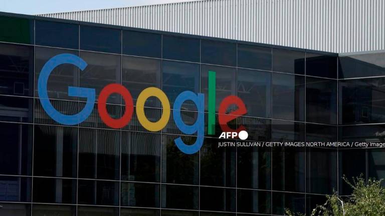 A sign is posted on the exterior of a building on the Google headquarters campus on July 23, 2025 in Mountain View, California. - Getty Images via AFP