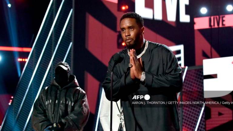 Honoree Sean 'Diddy' Combs (R) accepts the Lifetime Achievement Award presented by Coke from Kanye West and Babyface onstage during the 2022 BET Awards at Microsoft Theater on June 26, 2022 in Los Angeles, California. - Getty Images via AFP