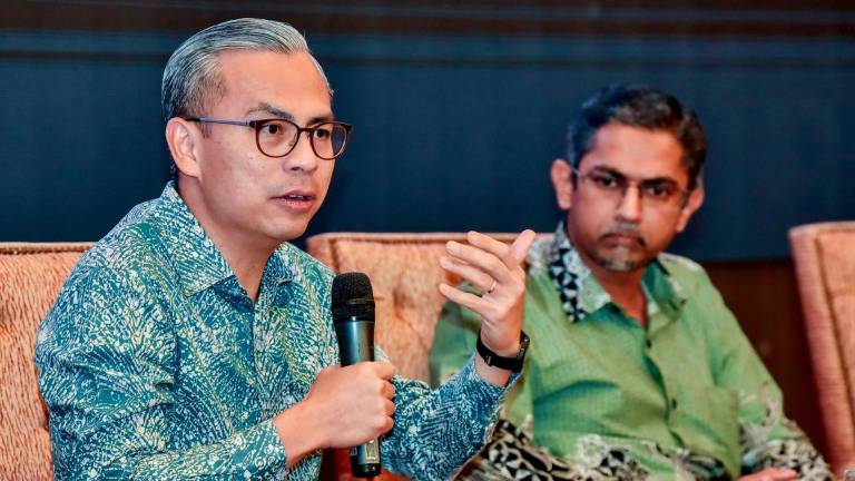 Communications Minister Datuk Fahmi Fadzil delivers a talk during the Keynote Forum: Online Safety in the World of AI with youths at the World Trade Centre Kuala Lumpur today. - BERNAMAPIX
