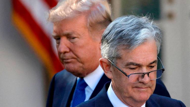 FILE PHOTO: U.S. President Donald Trump looks on as Jerome Powell, his nominee at the time to lead the U.S. Federal Reserve, moves to the podium at the White House in Washington, U.S., Nov 2, 2017 - REUTERS