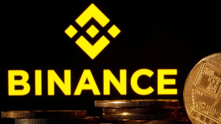 Representations of cryptocurrencies are seen in front of a displayed Binance logo in this illustration photo. – Reuterspic