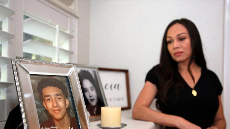 Megan Garcia stands next to a picture of her son Sewell Setzer III at her home in Orlando, Florida on October 9, 2025. (Photo by Gregg Newton / AFP)