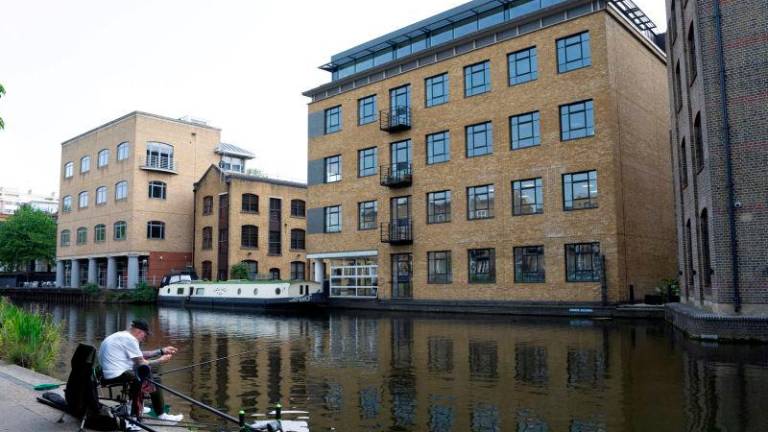 A man fishes during good weather in Regent’s Canal in London, Britain, May 2, 2025. REUTERSpix
