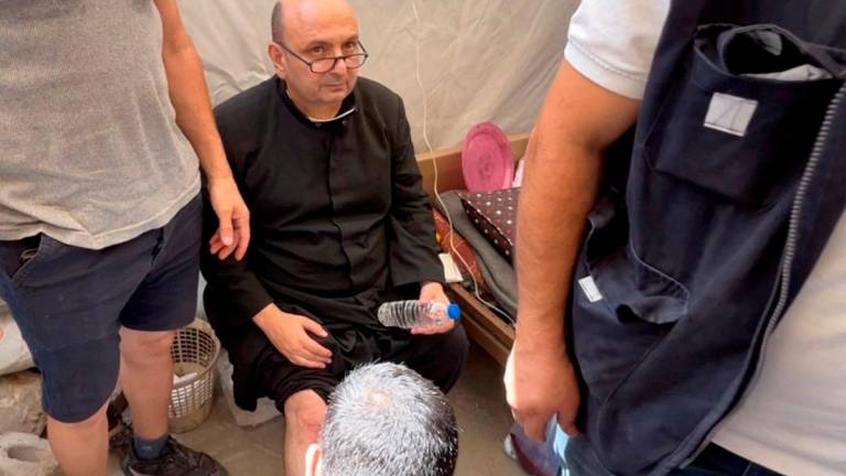 Parish priest of the Church of the Holy Family, father Gabriele Romanelli, receives medical attention, after he suffered light leg injuries following an Israeli strike on the church, according to medics, at Al-Ahli Arab Hospital in Gaza City, in this still image taken from a video July 17, 2025. - REUTERS/Dawoud Abu Alkas