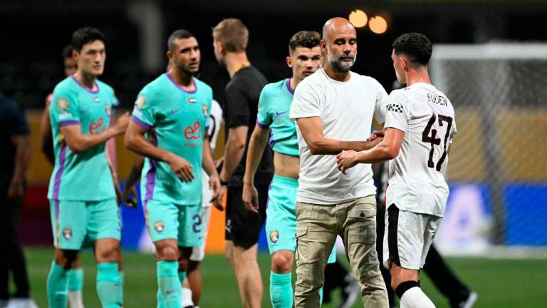 Manchester City’s Spanish head coach Pep Guardiola greets Manchester City’s English midfielder #47 Phil Foden at the end of the FIFA Club World Cup 2025 Group G football match between England’s Manchester City and UAE’s Al Ain FC at the Mercedes-Benz stadium in Atlanta on June 22, 2025 - AFP