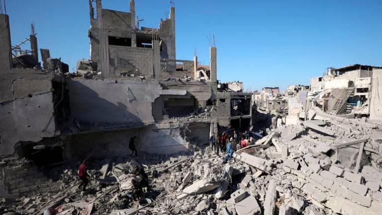 Palestinians search for casualties at the site of an Israeli airstrike on a house, amid the ongoing conflict between Israel and Hamas, in Gaza City - REUTERSpix