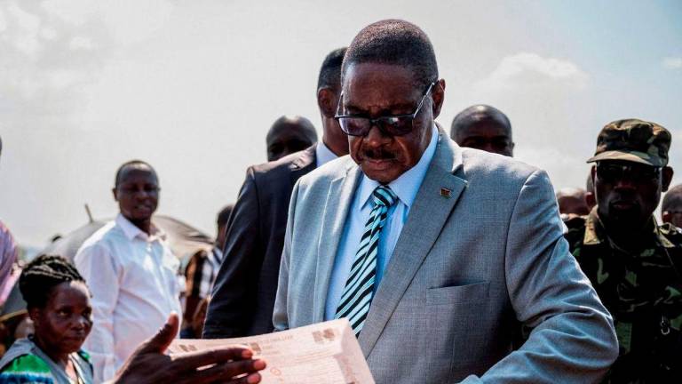 Malawi’s presidential candidate and leader of the Democratic Progressive Party Peter Mutharika inspects a ballot paper before casting his vote during the general election at Thyolo District, south of Blantyre, Malawi, September 16, 2025. - REUTERSPIX