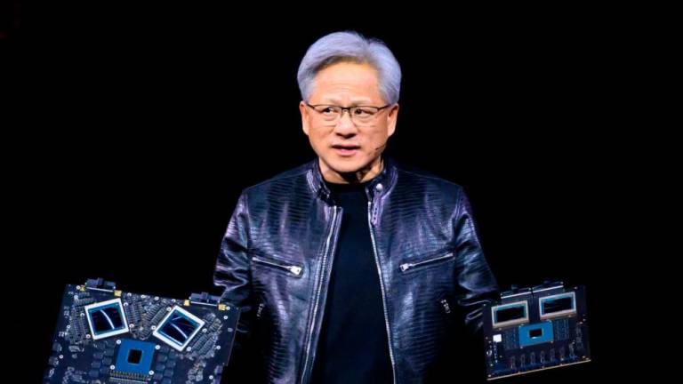 Huang displaying products on stage during the annual Nvidia GTC Artificial Intelligence Conference at SAP Center in San Jose, California, on Monday. – AFPpic