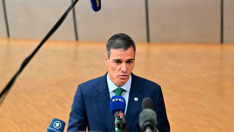 Spain’s Prime Minister Pedro Sanchez speaks to the press as he arrives to attend the European Council in Brussels on June 26, 2025. (Photo by NICOLAS TUCAT / AFP)