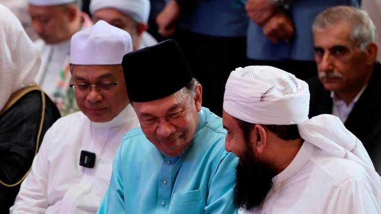 Prime Minister Datuk Seri Anwar Ibrahim speaking to Pakistani scholar Maulana Tariq Jamil during the ‘Malaysia Bermunajat 2025’ programme at the Putra Mosque- - Bernama pic
