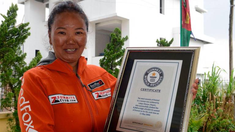 Nepalese climber Lhakpa Sherpa, who holds the world record for most successful climbs of Mount Everest for a woman with seven ascents, poses with her Guinness record certificate in Kathmandu on May 27, 2016. AFPpix