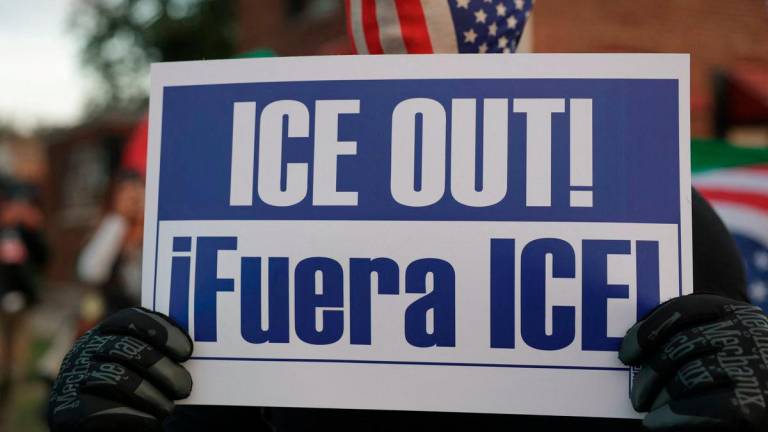 A demonstrator holds a sign during a protest against federal immigration action, outside the U.S. Immigration and Customs Enforcement (ICE) Broadview facility in Chicago, Illinois, U.S., October 10, 2025. - REUTERS