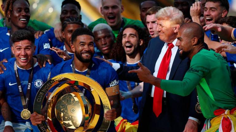 Chelsea’s Reece James and teammates celebrate with the trophy alongside U.S. President Donald Trump after winning the FIFA Club World Cup - REUTERS