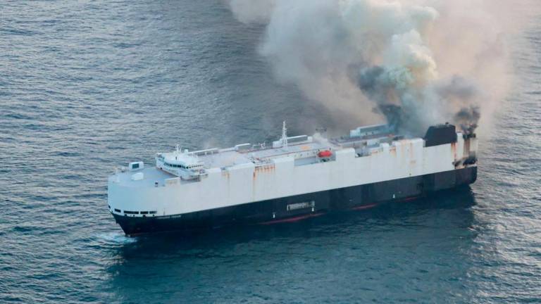 Smoke rises from a fire aboard the cargo vessel Morning Midas, carrying around 3,000 vehicles, including 800 electric vehicles, as seen in an aerial photograph taken from a U.S. Coast Guard C-130J Super Hercules, approximately 300 miles south of Adak, Alaska, U.S. June 3, 2025. - REUTERSPIX