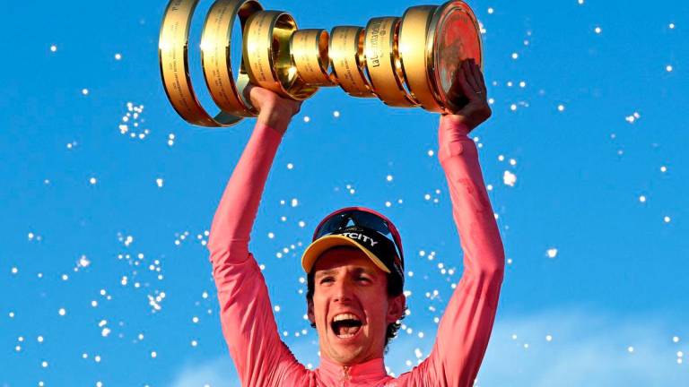Simon Yates celebrates with a trophy on the podium after winning the Giro d’Italia REUTERSpix