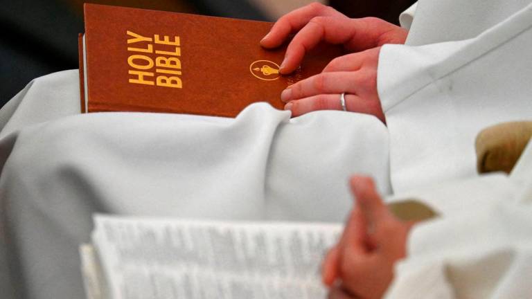 FILE PHOTO: Delegates sit with copies of the Bible whilst attending the Church of England General Synod meeting in London, Britain, February 9, 2023. REUTERS/Toby Melville/File Photo
