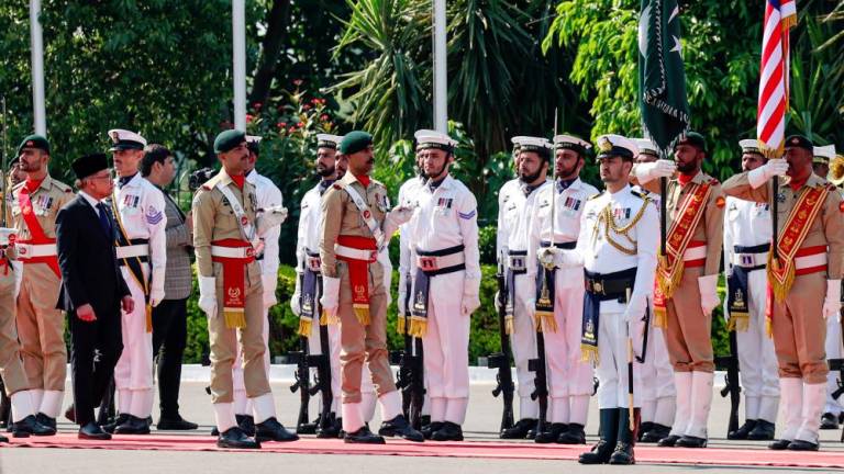 Datuk Seri Anwar Ibrahim inspects the guard of honour during a state visit at the Official Residence of the Prime Minister of Pakistan - BERNAMApix