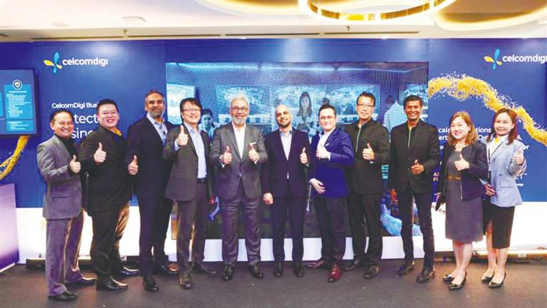 Afizulazha (fifth, left) at the launch of CelcomDigi’s AI-driven cybersecurity solutions.