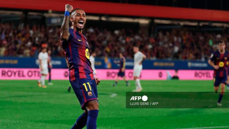 Barcelona's Brazilian forward #11 Raphinha celebrates scoring his team's fourth goal during the Spanish league football match between FC Barcelona and Valencia CF at Johan Cruyff Stadium in Barcelona, on September 14, 2025. - AFP