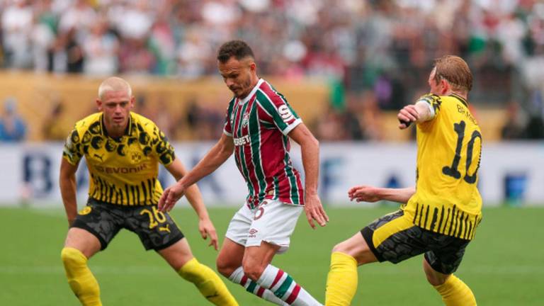 Rene #6 of Fluminense FC runs with the ball while under pressure from Julian Brandt #10 and Julian Ryerson #26 of Borussia Dortmund during the FIFA Club World Cup 2025 group F match between Fluminense FC and Borussia Dortmund at MetLife Stadium on June 17, 2025 in East Rutherford, New Jersey. - AFPPIX