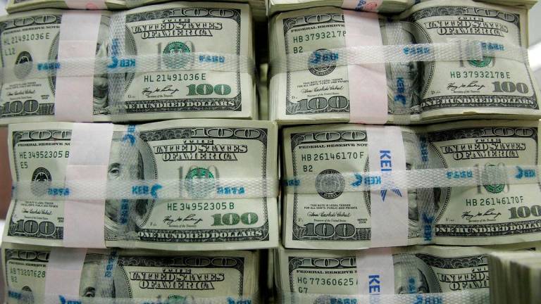 Filepix; Stacks of one hundred dollar notes are piled up for counting at the headquarters of the Korea Exchange Bank in Seoul February 3, 2009. REUTERSpix