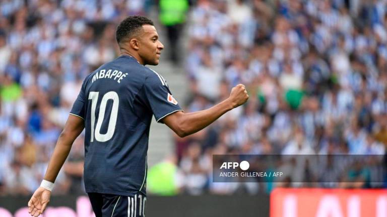Real Madrid's French forward #10 Kylian Mbappe celebrates scoring his team's first goal during the Spanish league football match between Real Sociedad and Real Madrid CF at Anoeta Stadium in San Sebastian on September 13, 2025. - AFP