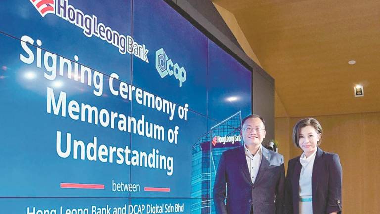 Woon (left) and Ng at the MoU signing ceremony.