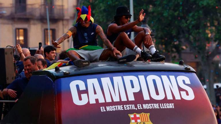 FC Barcelona’s Raphinha and Jules Kounde celebrate winning LaLiga on the bus during the parade REUTERSpix