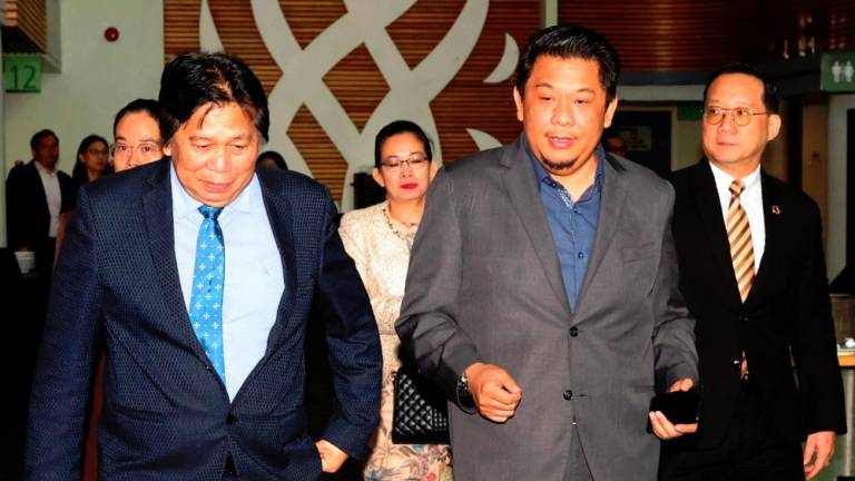 Datuk Dr Malcolm Mussen Lamoh (left) - BERNAMApix