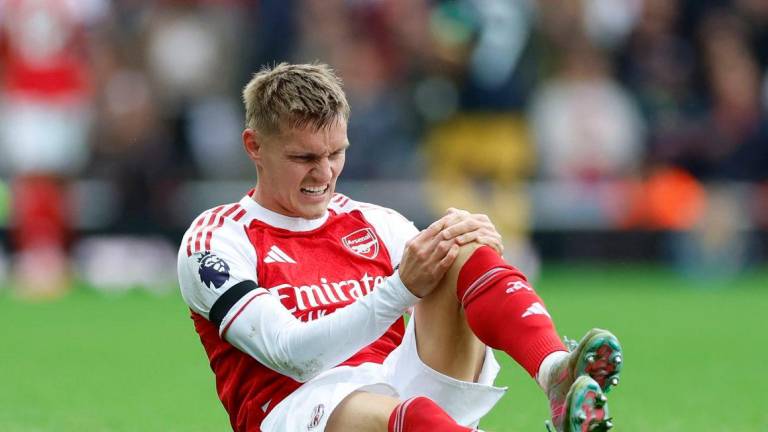Martin Odegaard reacts after sustaining an injury Action Images via Reuters/Peter Cziborra