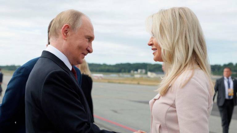 Russian President Vladimir Putin shakes hands with Chief of Protocol of the United States Monica Crowley upon departure following his meeting with U.S. President Donald Trump in Anchorage, Alaska, U.S., August 15, 2025. Sputnik/Gavriil Grigorov/Pool via REUTERS