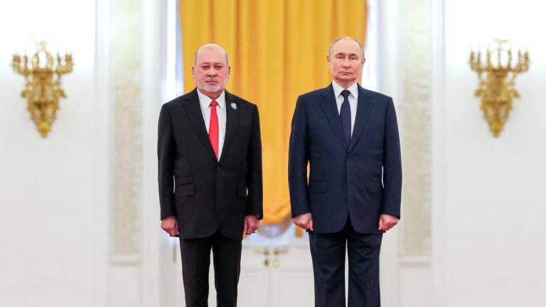 In this pool photograph distributed by the Russian state agency Sputnik, Russia’s President Vladimir Putin and Malaysia’s King Sultan Ibrahim attend a welcoming ceremony prior to their talks at the Kremlin in Moscow on August 6, 2025. - Pool via AFP