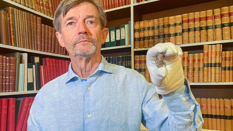 Denmark’s national museum curator Peter Pentz shows a gaming piece which is believed to be the first portrait of a Viking, on August 26, 2025 in Copenhagen. - Camille BAS-WOHLERT / AFP