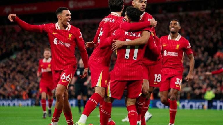 Premier League - Liverpool v Manchester City - Anfield, Liverpool, Britain - December 1, 2024 Liverpool's Cody Gakpo celebrates scoring their first goal with Mohamed Salah and Dominik Szoboszlai - REUTERSPIX