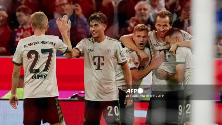 Bayern Munich's English forward #09 Harry Kane (2R) celebrates with teammates scoring his team's third goal during the German first division Bundesliga football match between Bayern Munich and Werder Bremen in Munich on Spetember 26, 2025. - AFPPIX