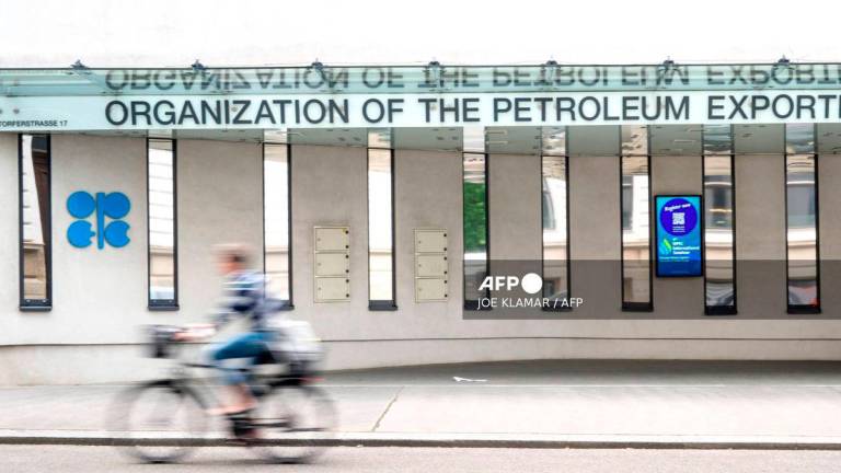 A cyclist rides past the building headquarters of OPEC (Organization of The Petroleum Exporting Countries) in Vienna, Austria on May 28, 2025, as Ministers of the OPEC+ oil alliance, led by Saudi Arabia and Russia, hold talks online. - AFP
