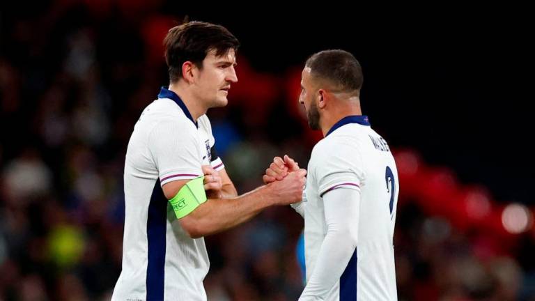 Football - International Friendly - England v Brazil - Wembley Stadium, London, Britain - March 23, 2024England's Harry Maguire receives the captain's armband as Kyle Walker is substituted off- REUTERSPIX