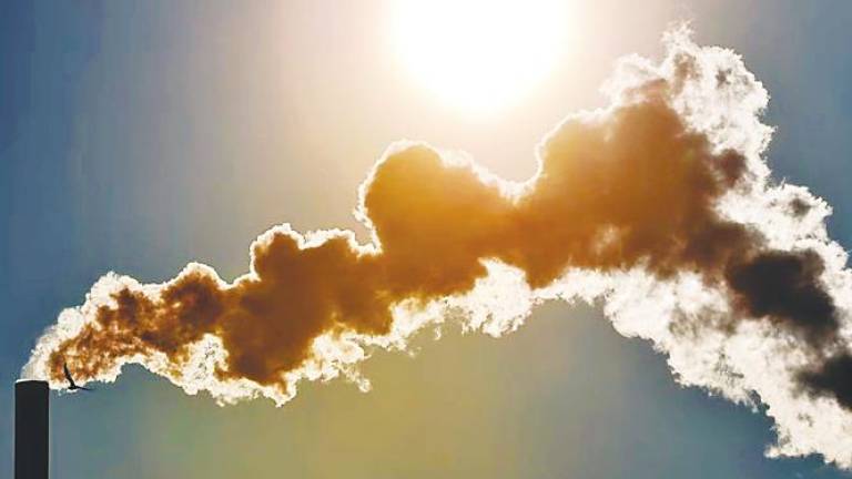 View of smoke billowing from a chimney. Economists caution that Malaysia’s plan to roll out a carbon tax in 2026 may face challenges, particularly in balancing environmental goals with industrial competitiveness. – AFP filepic