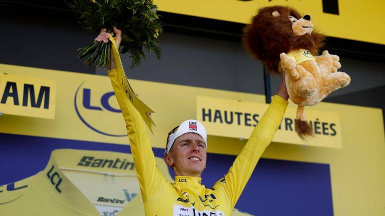 UAE Team Emirates XRG’s Tadej Pogacar celebrates on the podium wearing the yellow jersey after winning stage 12 - REUTERS