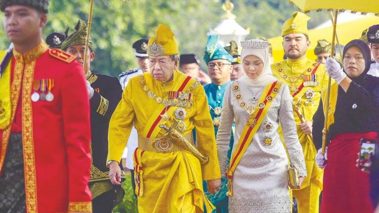 Sultan Sharafuddin and Tengku Permaisuri Norashikin arriving with Tengku Amir Shah for the ceremony yesterday. – ADAM AMIR HAMZAH/THESUN