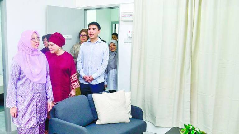 Zaliha (left) visits one of the Residensi Kecapi low-cost housing units. – ADAM AMIR HAMZAH/THESUN