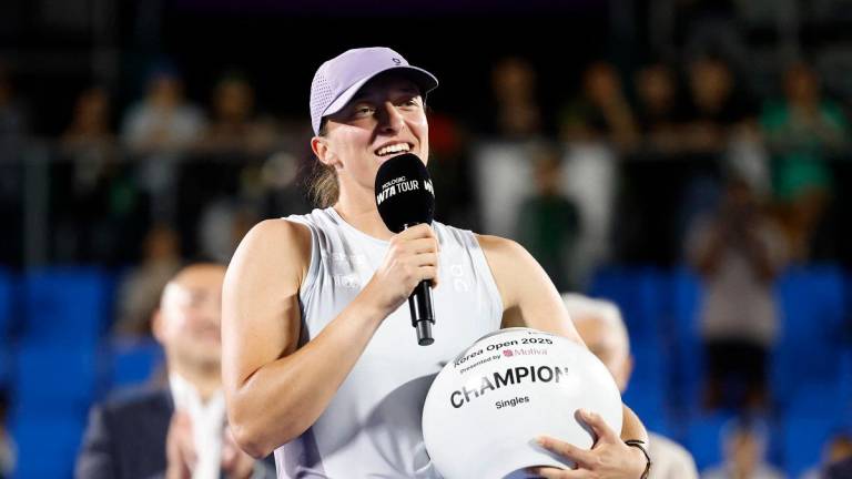 Poland’s Iga Swiatek celebrates with the trophy after winning her singles final against Russia’s Ekaterina Alexandrova. - REUTERS/Kim Soo-Hyeon