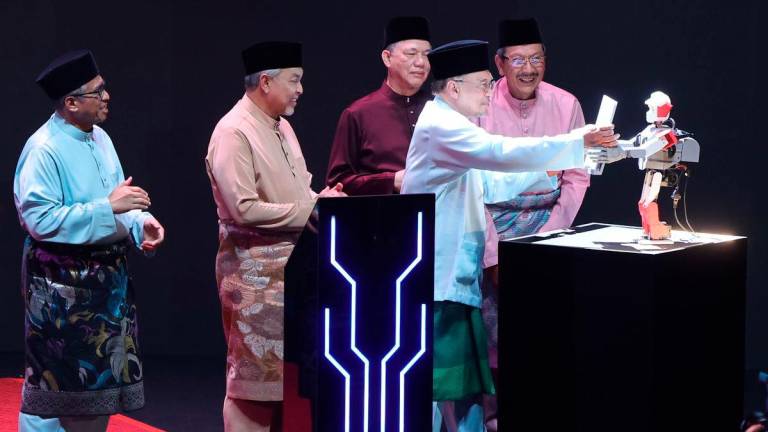 Prime Minister Datuk Seri Anwar Ibrahim (second, right) launches the Public Service Talent Development Policy book in conjunction with the 20th Public Service Premier Address (MAPPA XX) at the Putrajaya International Convention Centre (PICC) today. - BERNAMA