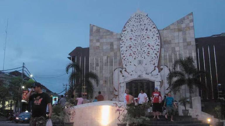 A tourist crosses the street from the Ground Zero Monument in Kuta, Bali - REUTERSpix