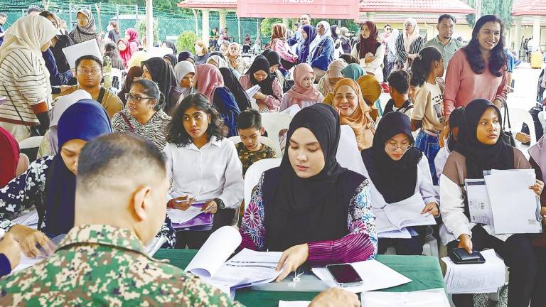 Female trainees at the registration session for the NS training programme at the 515th Regiment of Territorial Army Camp in Kuala Lumpur yesterday. – ADIB RAWI YAHYA/THESUN