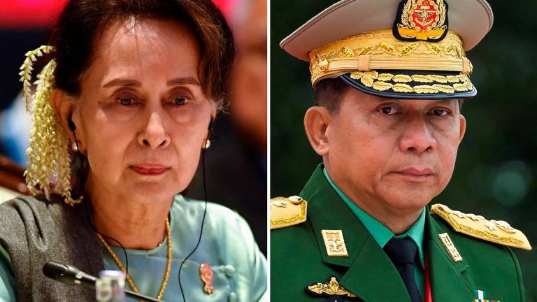 Myanmar’s deposed democratic leader Aung San Suu Kyi (L) and Myanmar military chief Senior General Min Aung Hlaing. AFPpix